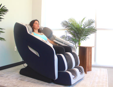 Woman relaxing in a massage chair in a modern room with plants