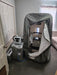 Sitting hyperbaric chamber in a gray room on a wooden floor with accessory units attached
