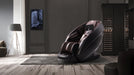 Modern massage chair in a room with a television and shelves.