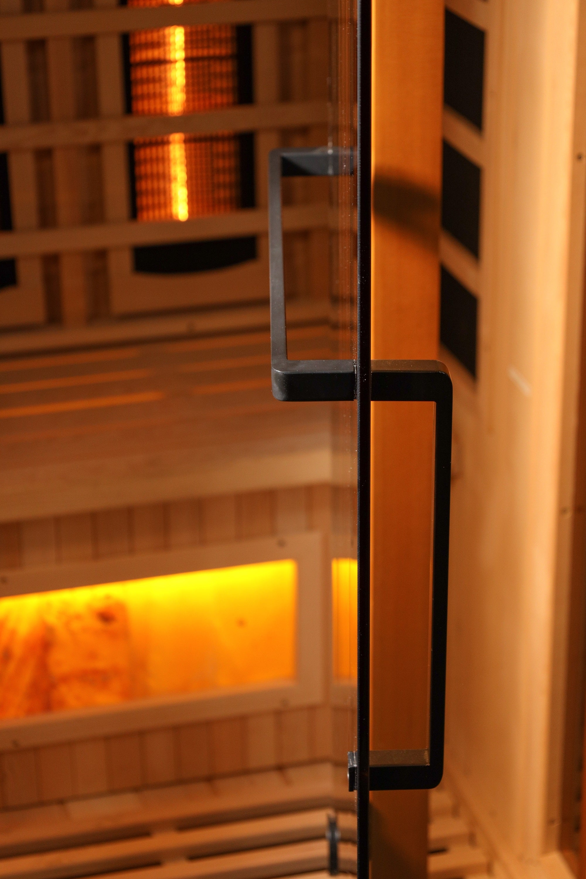 Wooden sauna with glowing interior and glass door