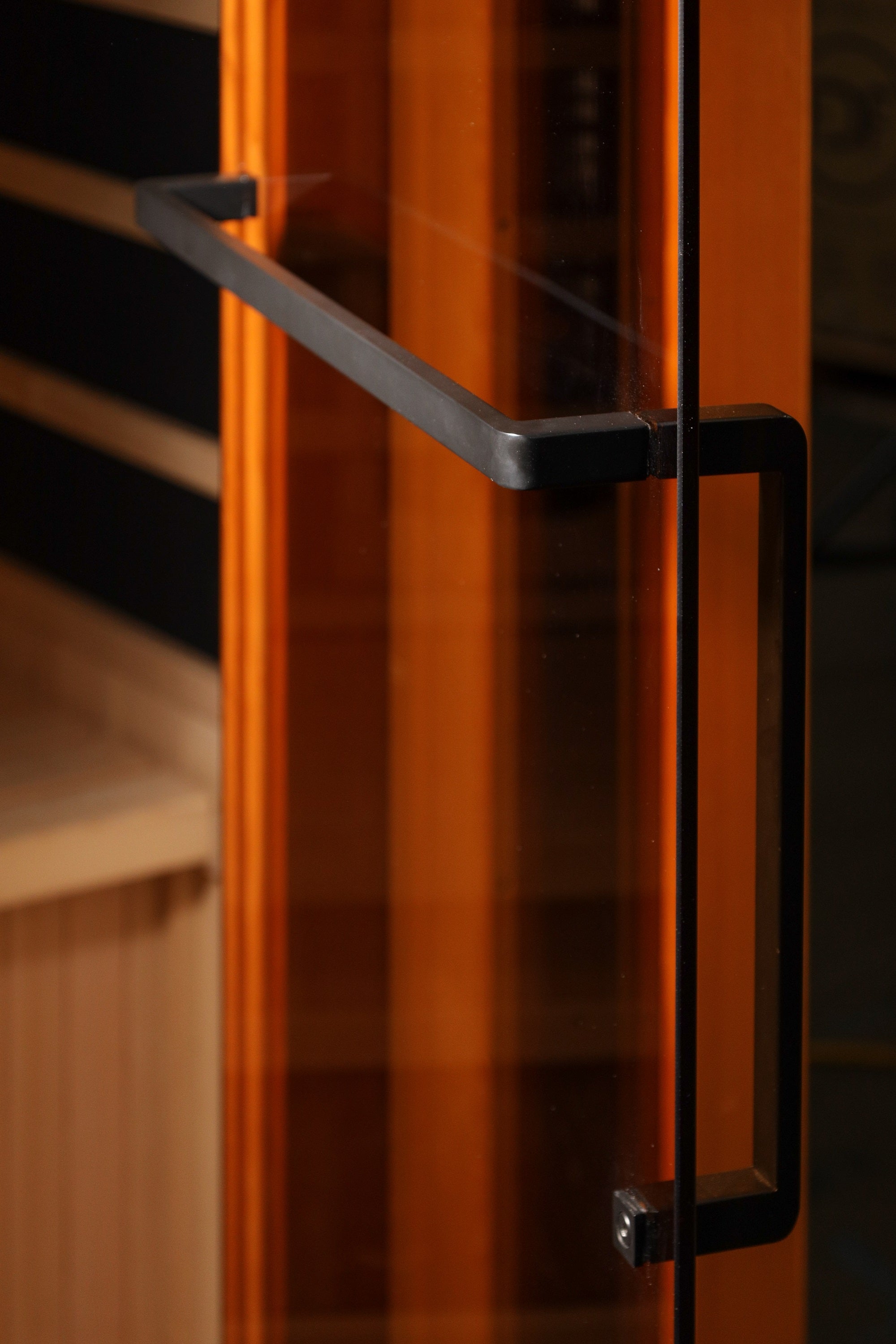Close-up of a glass door with black handles on a blurred background