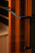 Close-up of a glass door with black handles on a blurred background