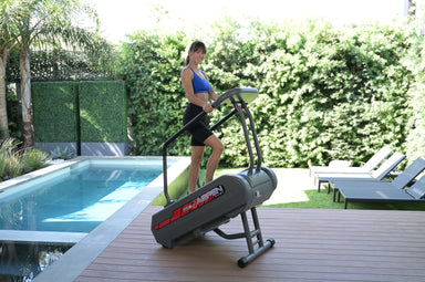 Stepmill exercise machine with woman using it outside by pool