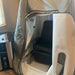 Personal airlock with a black seat inside, next to an air purifier labeled 'AIRVIDA'.