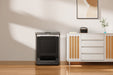 Black folded treadmill stored by wall in a modern living room setting