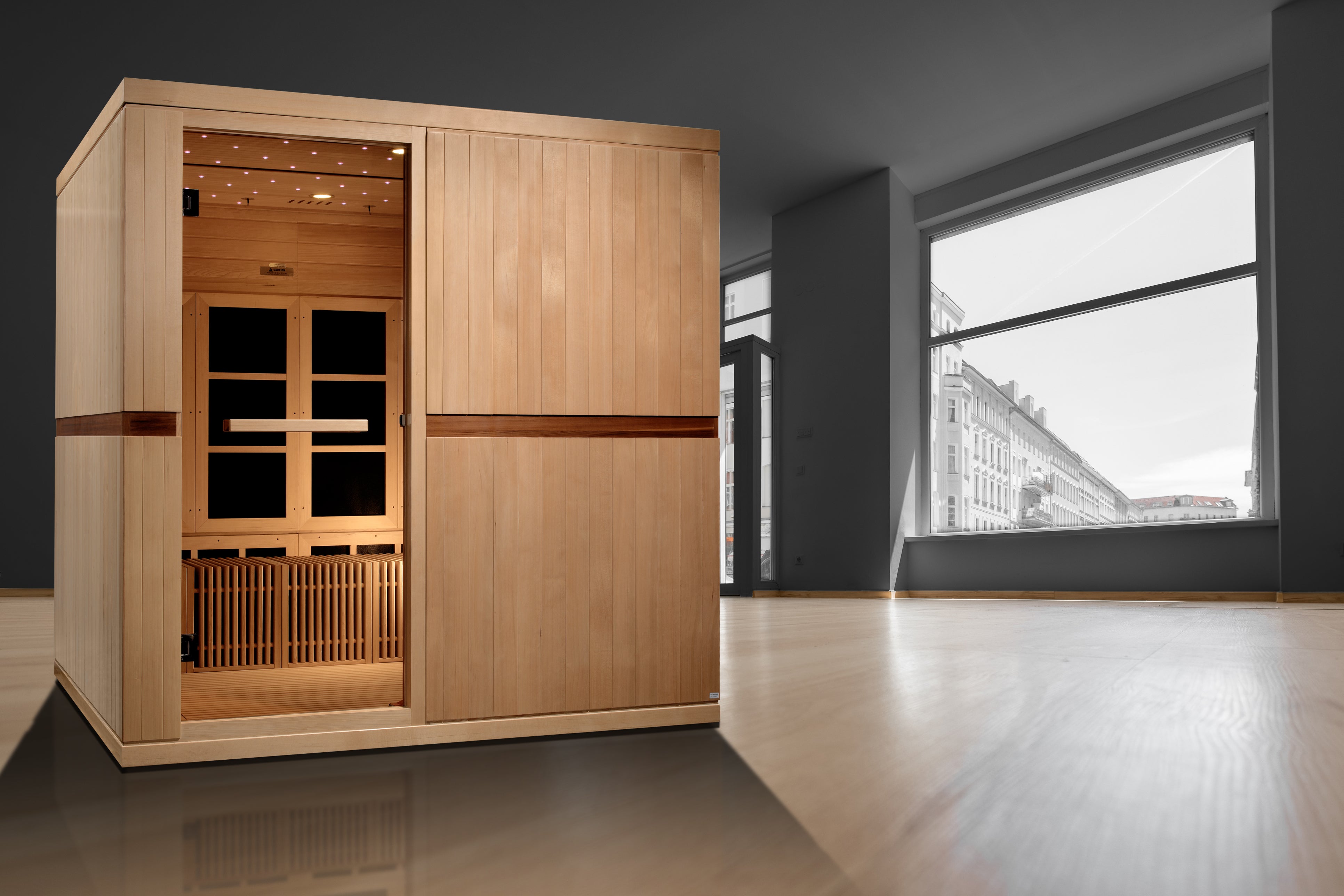 Wooden sauna in a modern room with large windows