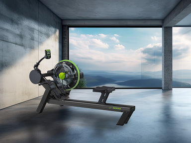 Rowing machine in a modern room with large windows showing a scenic view.