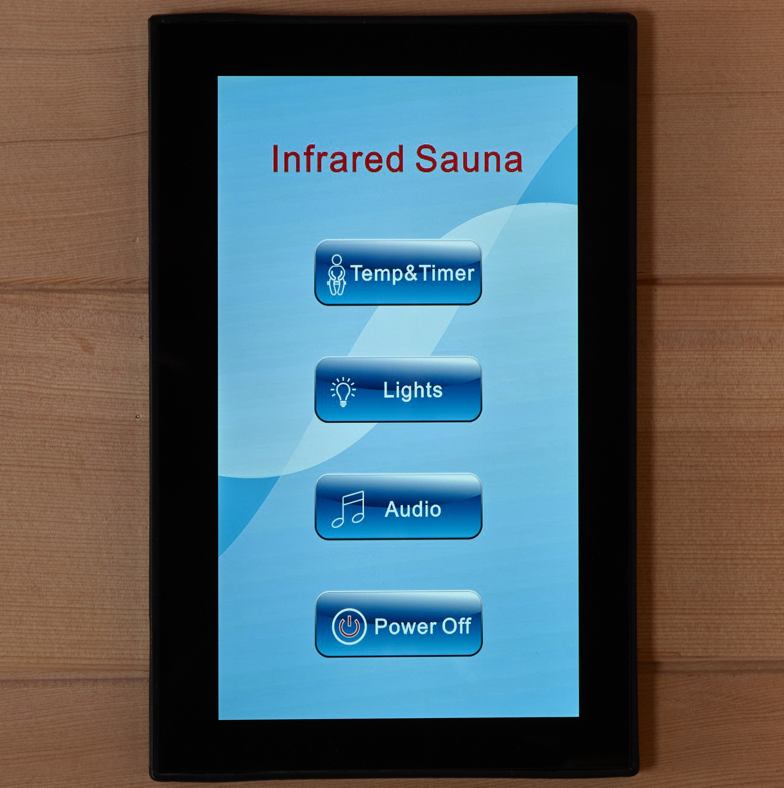 Touchscreen control panel for an infrared sauna on a wooden surface