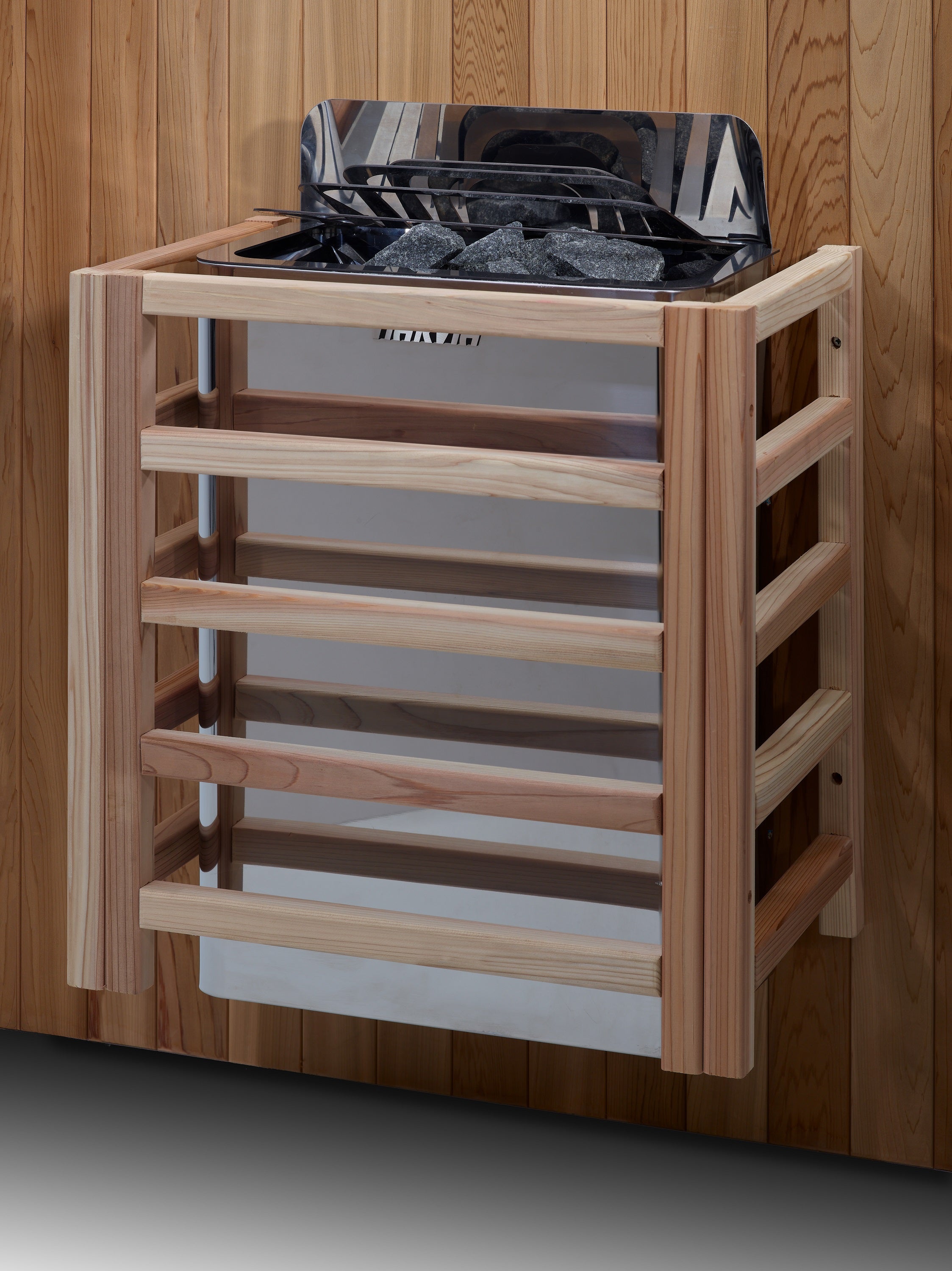 Wooden sauna shelf with black metal tray against a wooden wall.