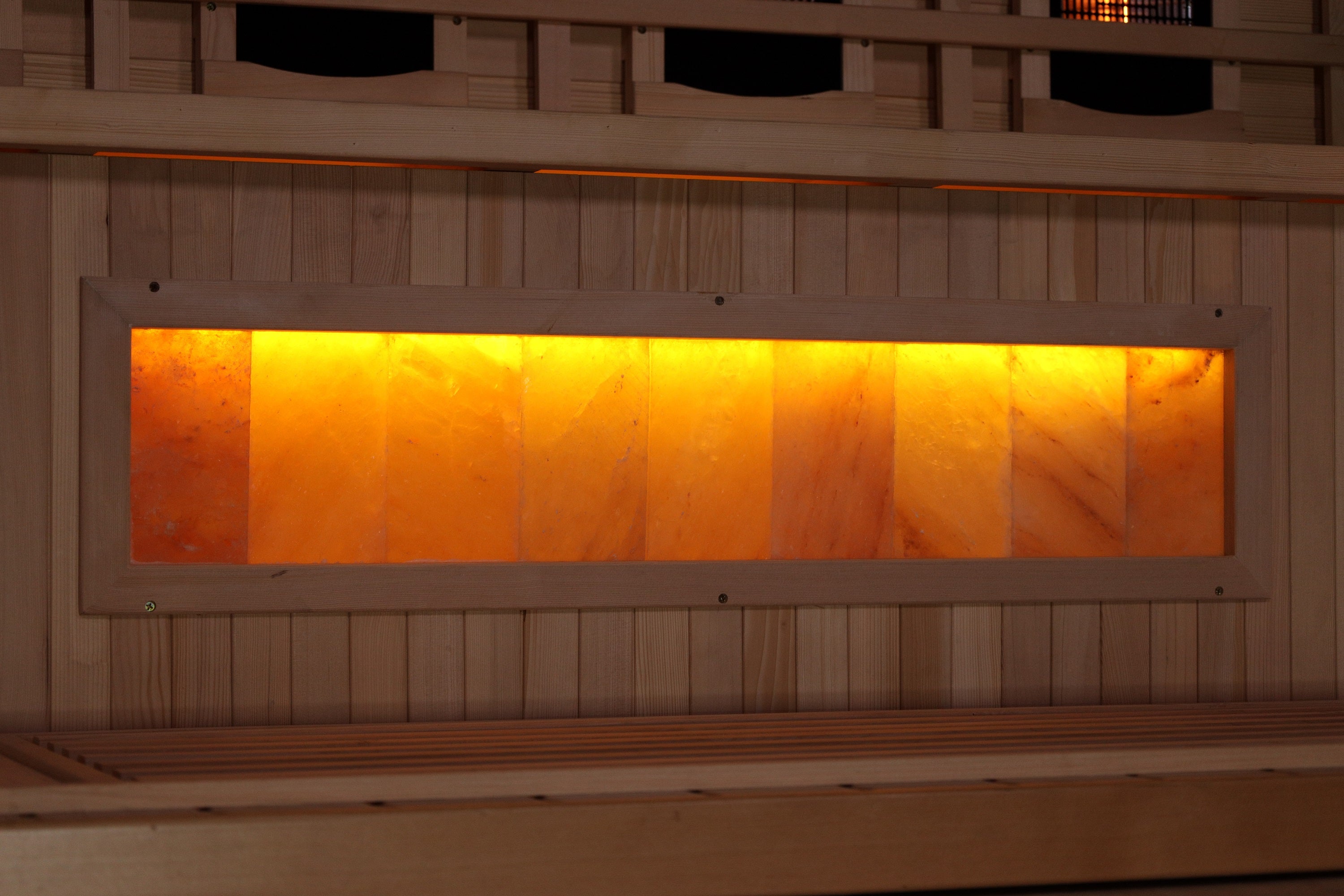 Wooden sauna with a glowing interior panel