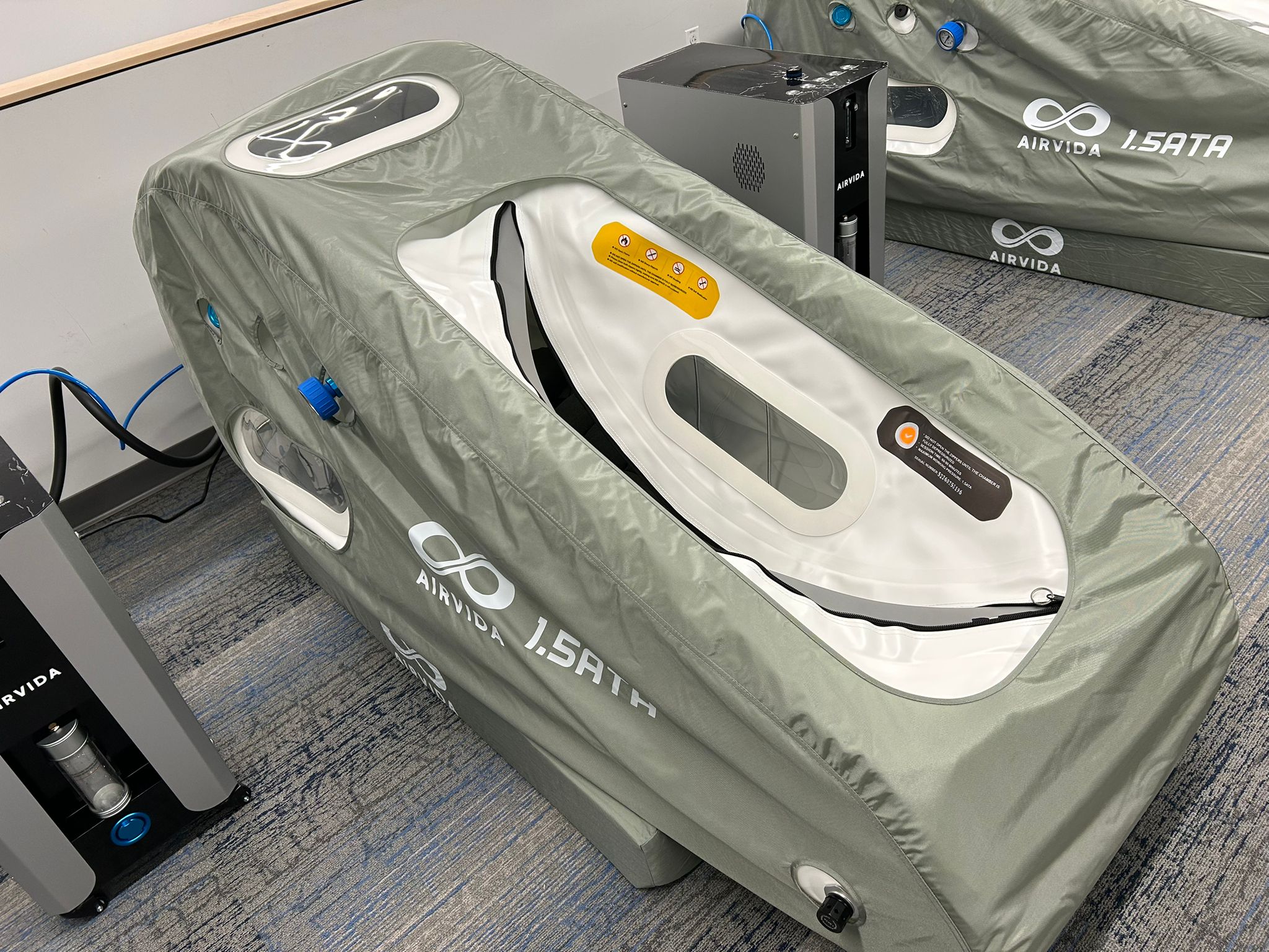 Hyperbaric chamber with 'AIRVIA' branding on a carpeted floor.