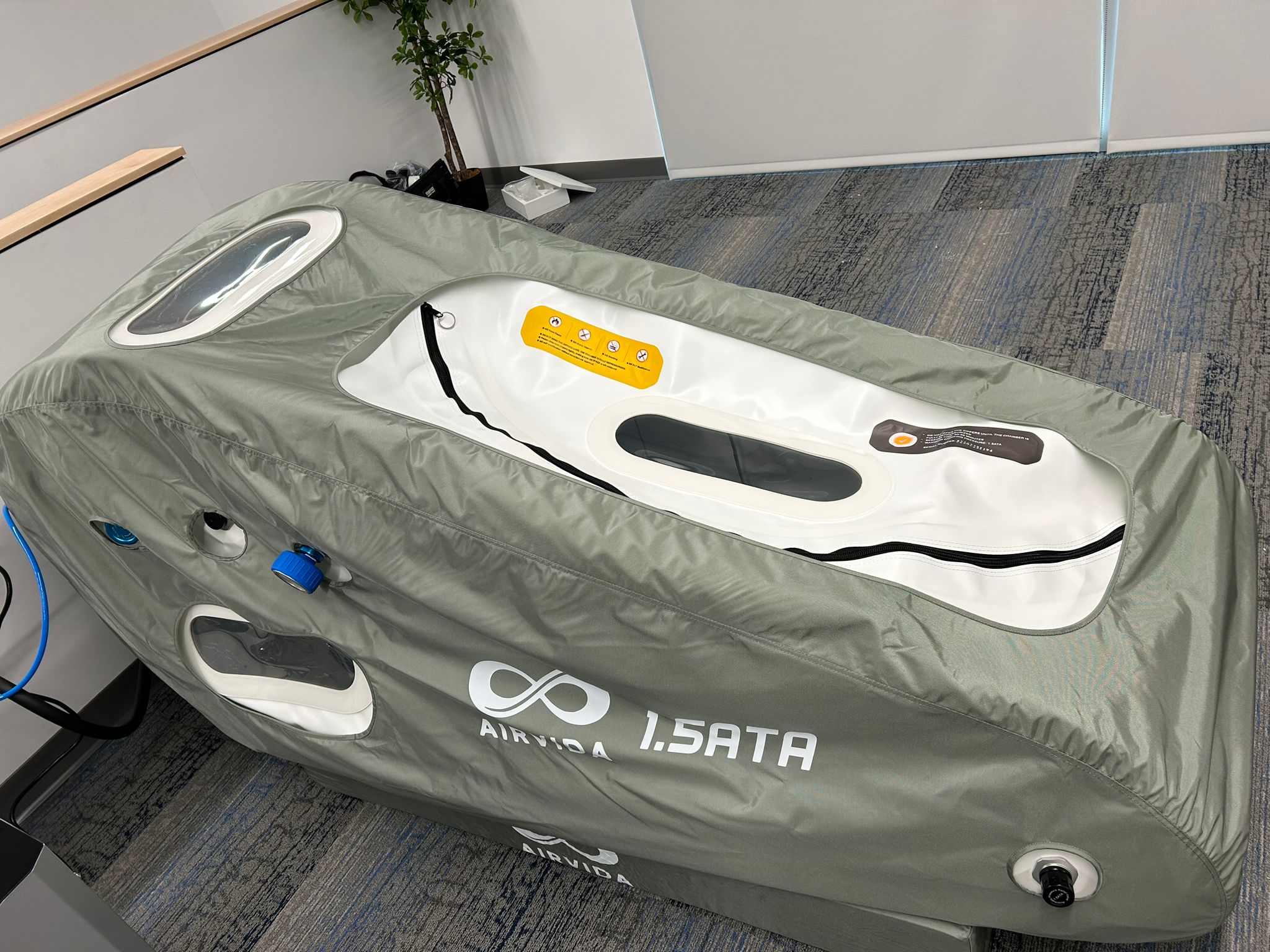 Hyperbaric chamber with 'AIRVIA' branding on a carpeted floor.