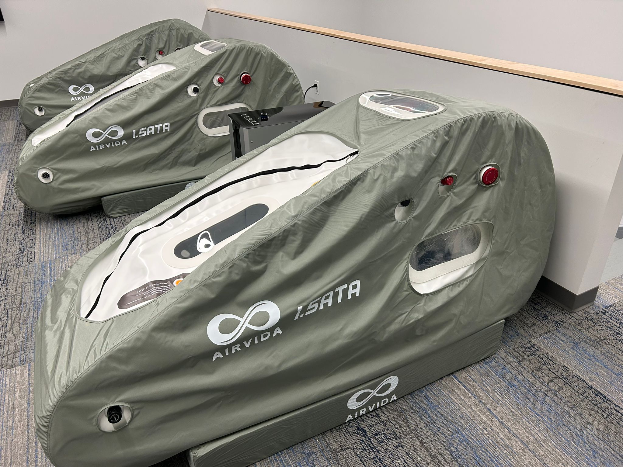 3 Hyperbaric chambers with 'AIRVIA' branding on a carpeted floor.
