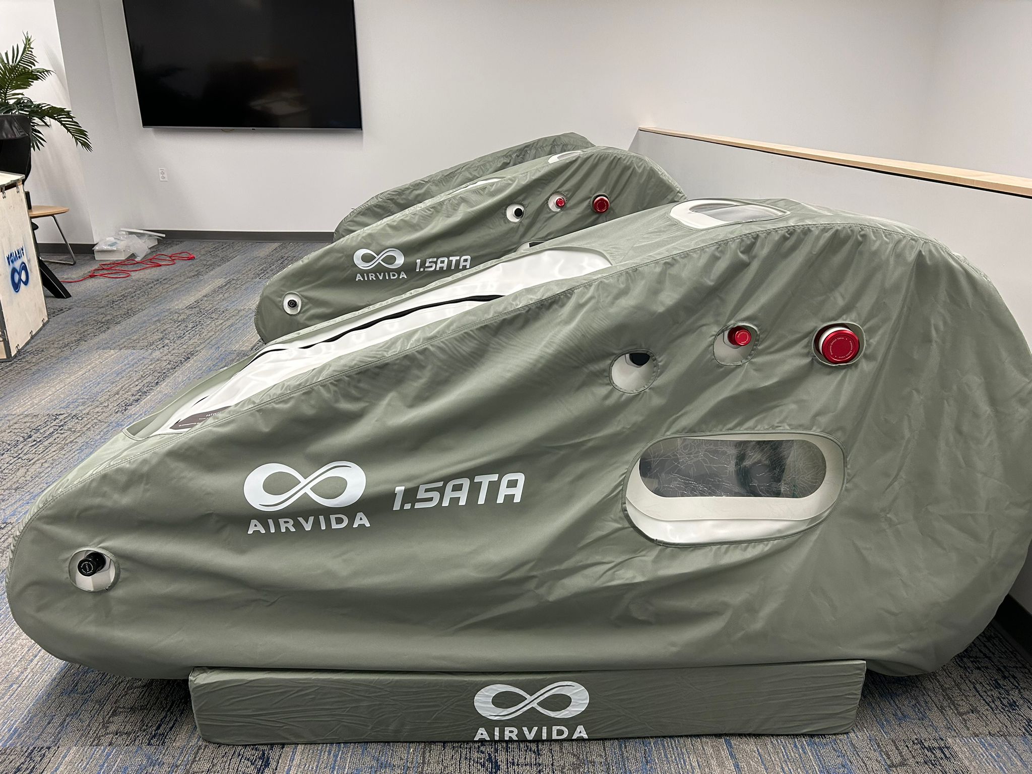 3 Hyperbaric chambers with 'AIRVIA' branding on a carpeted floor.