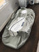 Gray and white hyperbaric chamber on a wooden floor