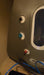 Sitting hyperbaric chamber with gauges in a tan room on a tile floor