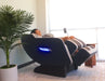 Person using a massage chair in a modern room with a plant and window.