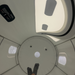 Feet of a person laying in aGray and white hyperbaric chamber 