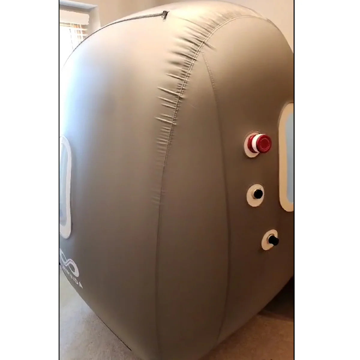Inflatable pod with control buttons on a light-colored floor