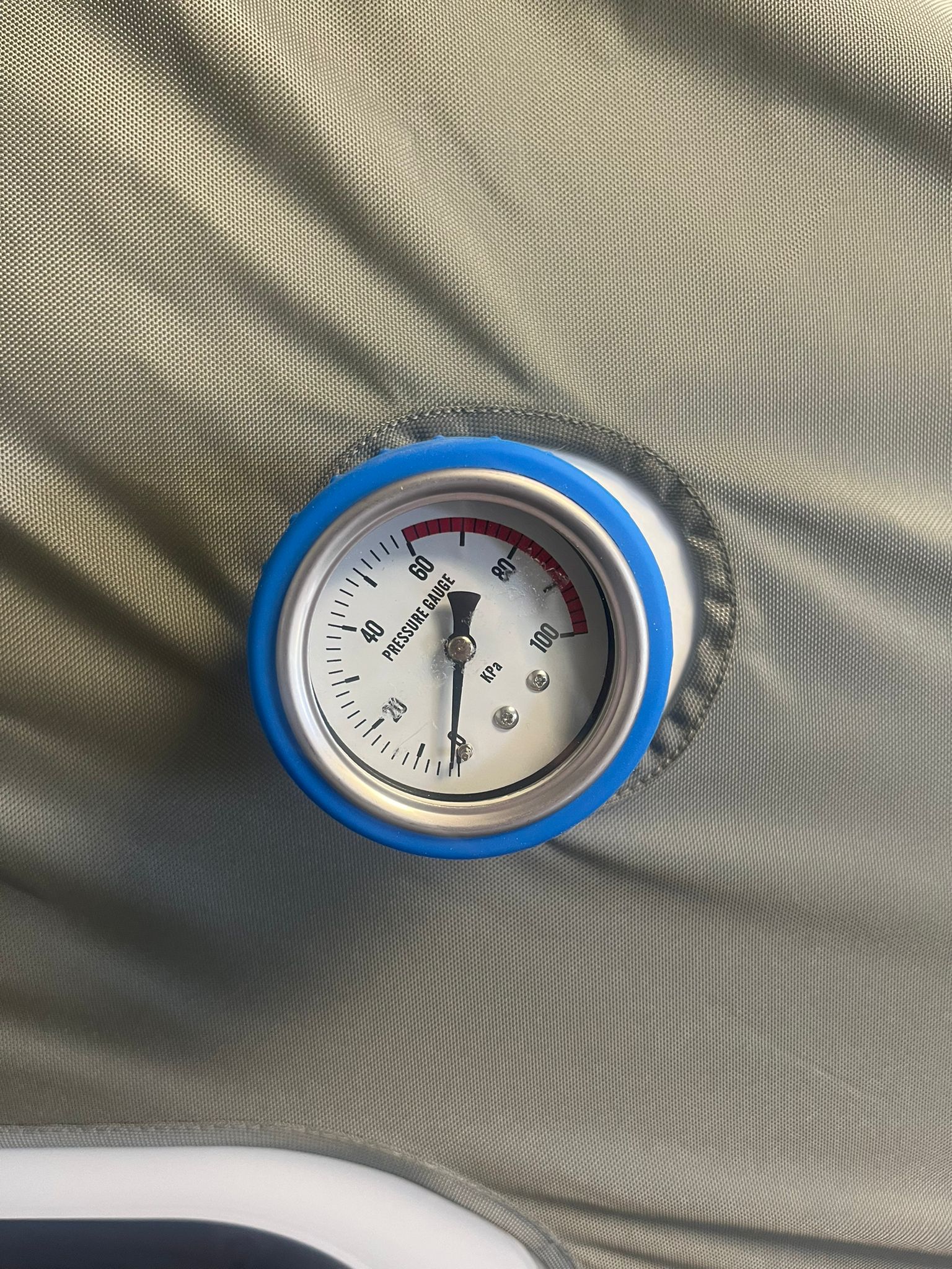 Pressure gauge on a gray fabric surface