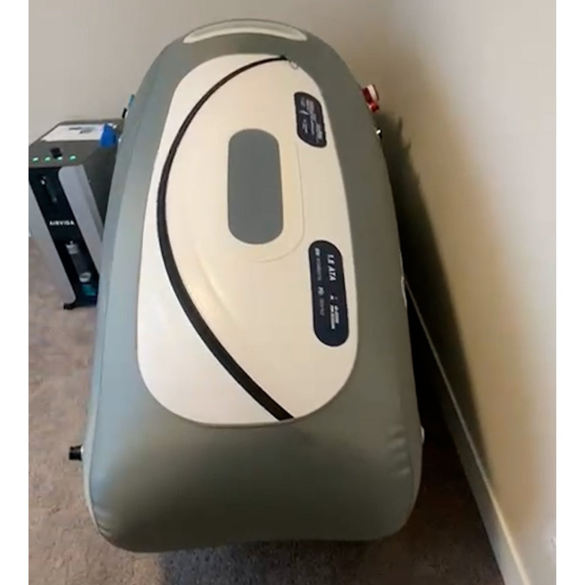 Hyperbaric chamber with 'AIRVIA' branding on a carpeted floor.