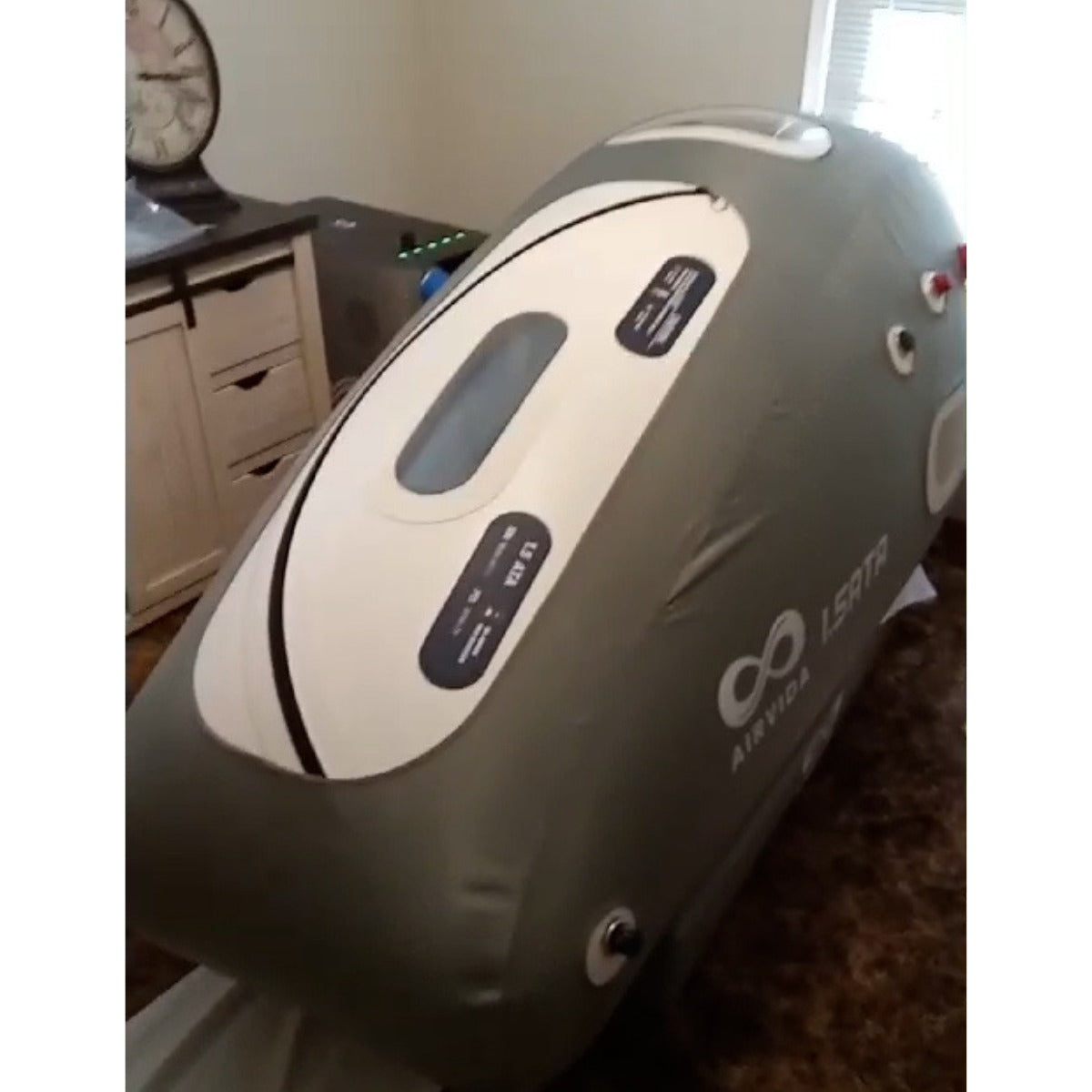 Hyperbaric chamber with 'AIRVIA' branding on a carpeted floor.