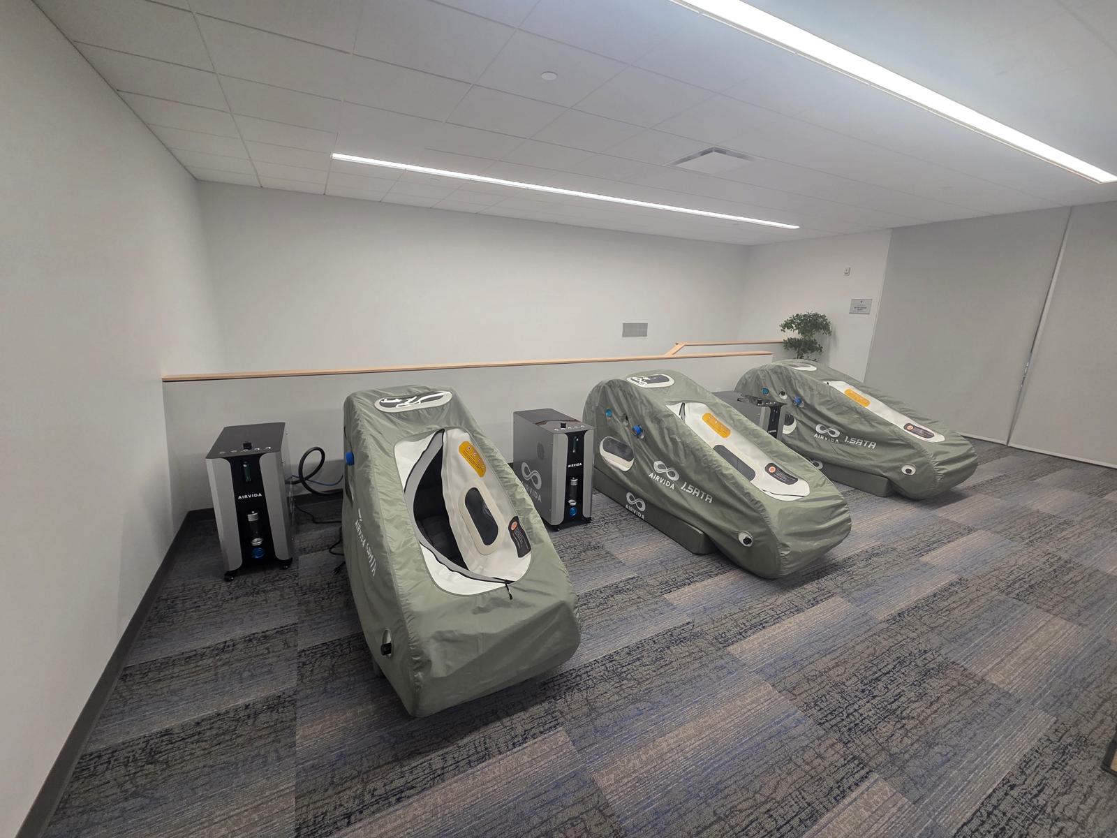 3 Hyperbaric chambers with 'AIRVIA' branding on a carpeted floor.